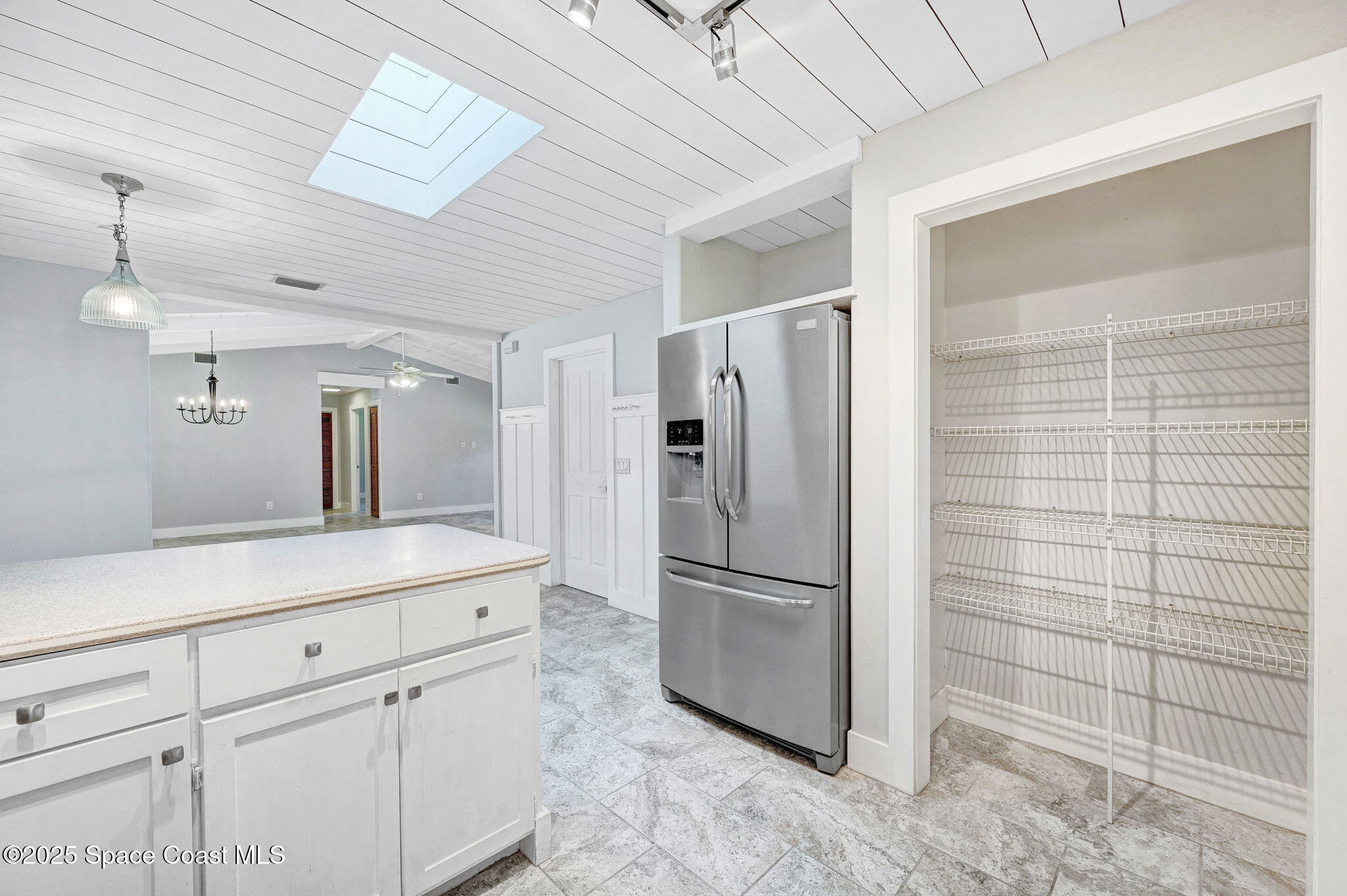3301 Grant Road Grant-Valkaria, FL 32949 - Photo 16 of 56 a kitchen with a refrigerator and cabinets