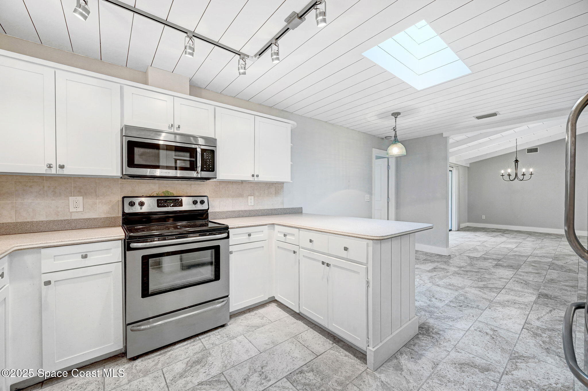 3301 Grant Road Grant-Valkaria, FL 32949 - Photo 17 of 56 a kitchen with stainless steel appliances granite countertop a stove top oven a sink dishwasher and a refrigerator