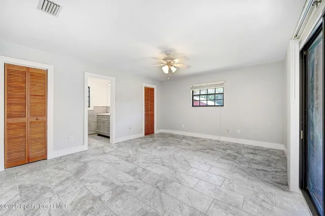 an empty room with windows and closet