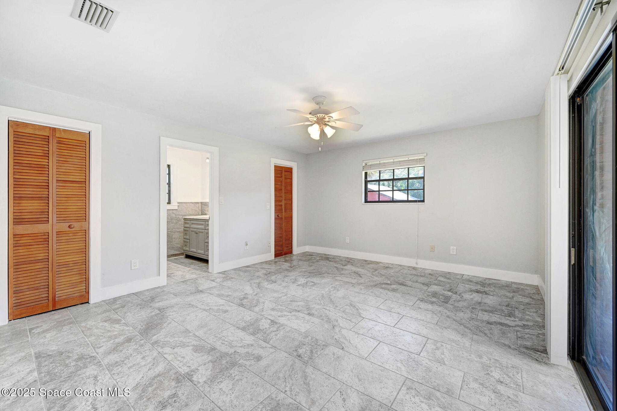 3301 Grant Road Grant-Valkaria, FL 32949 - Photo 18 of 56 an empty room with windows and closet