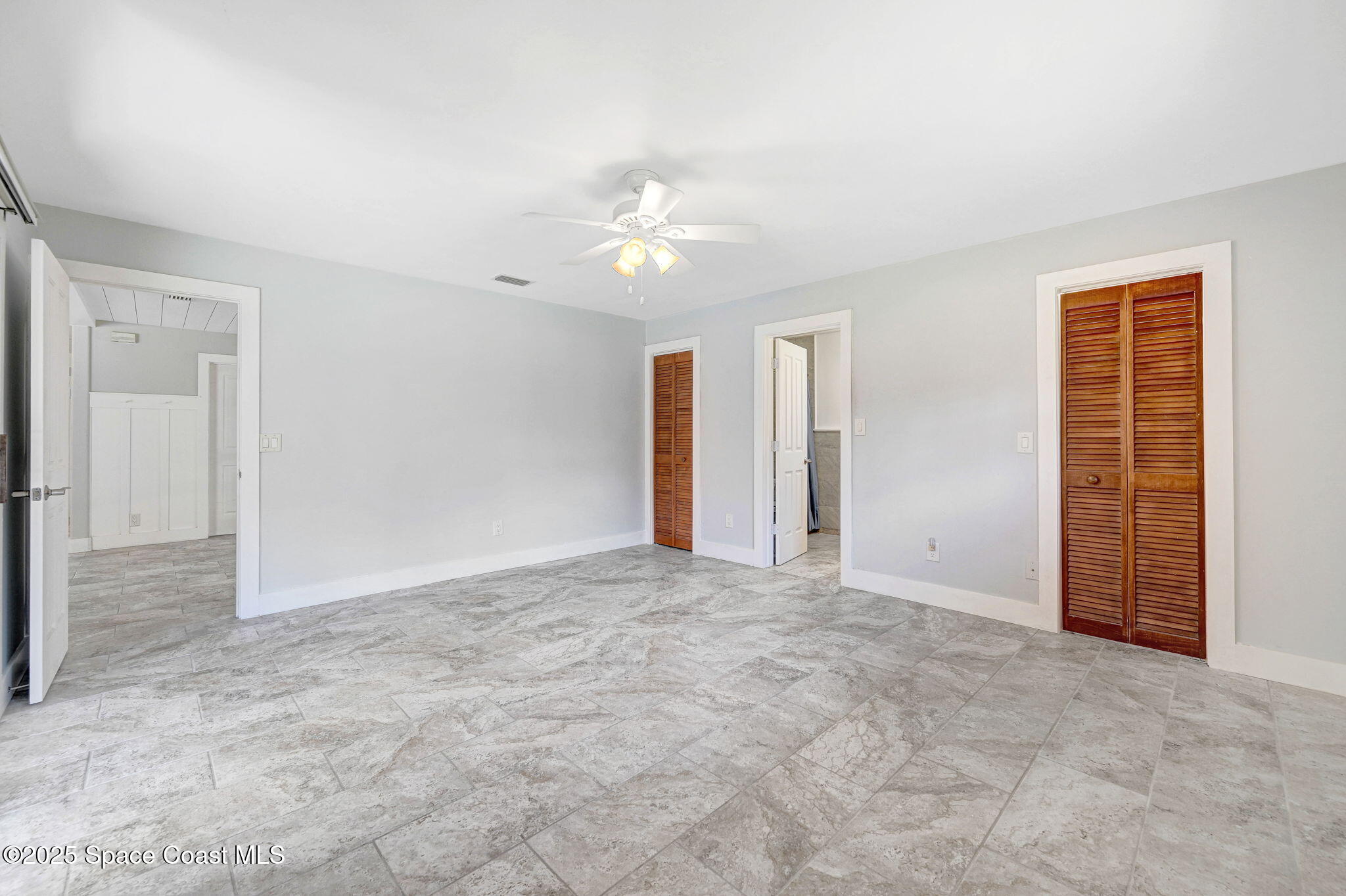 3301 Grant Road Grant-Valkaria, FL 32949 - Photo 19 of 56 an empty room with closet and a ceiling fan