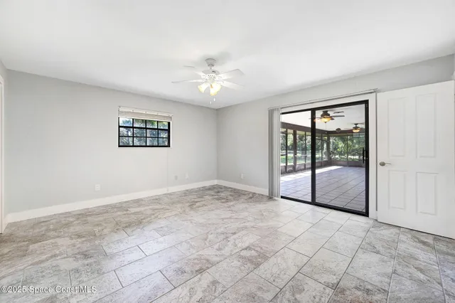 a view of an empty room with glass door