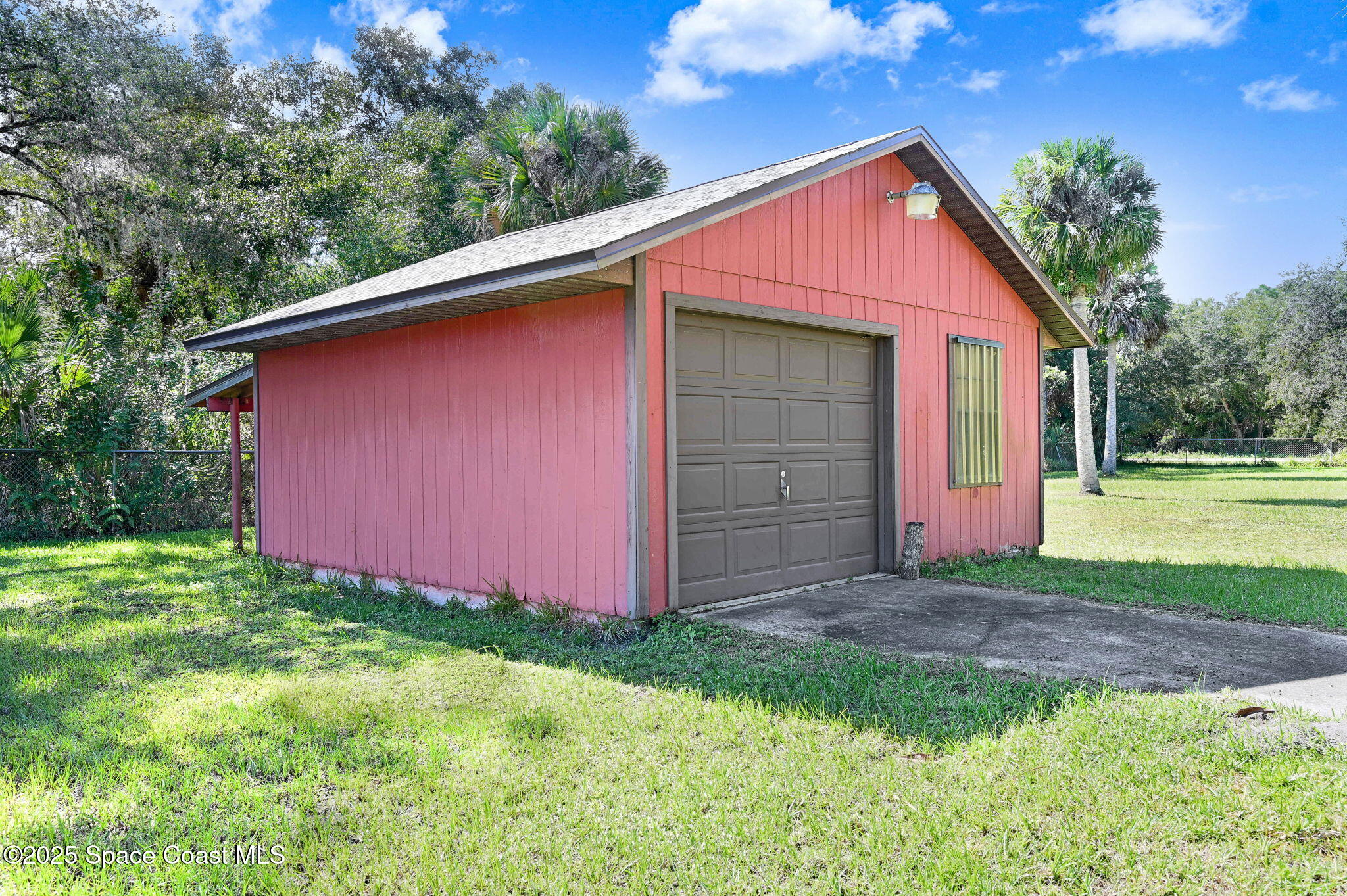 3301 Grant Road Grant-Valkaria, FL 32949 - Photo 34 of 56 a backyard of a house with lots of green space