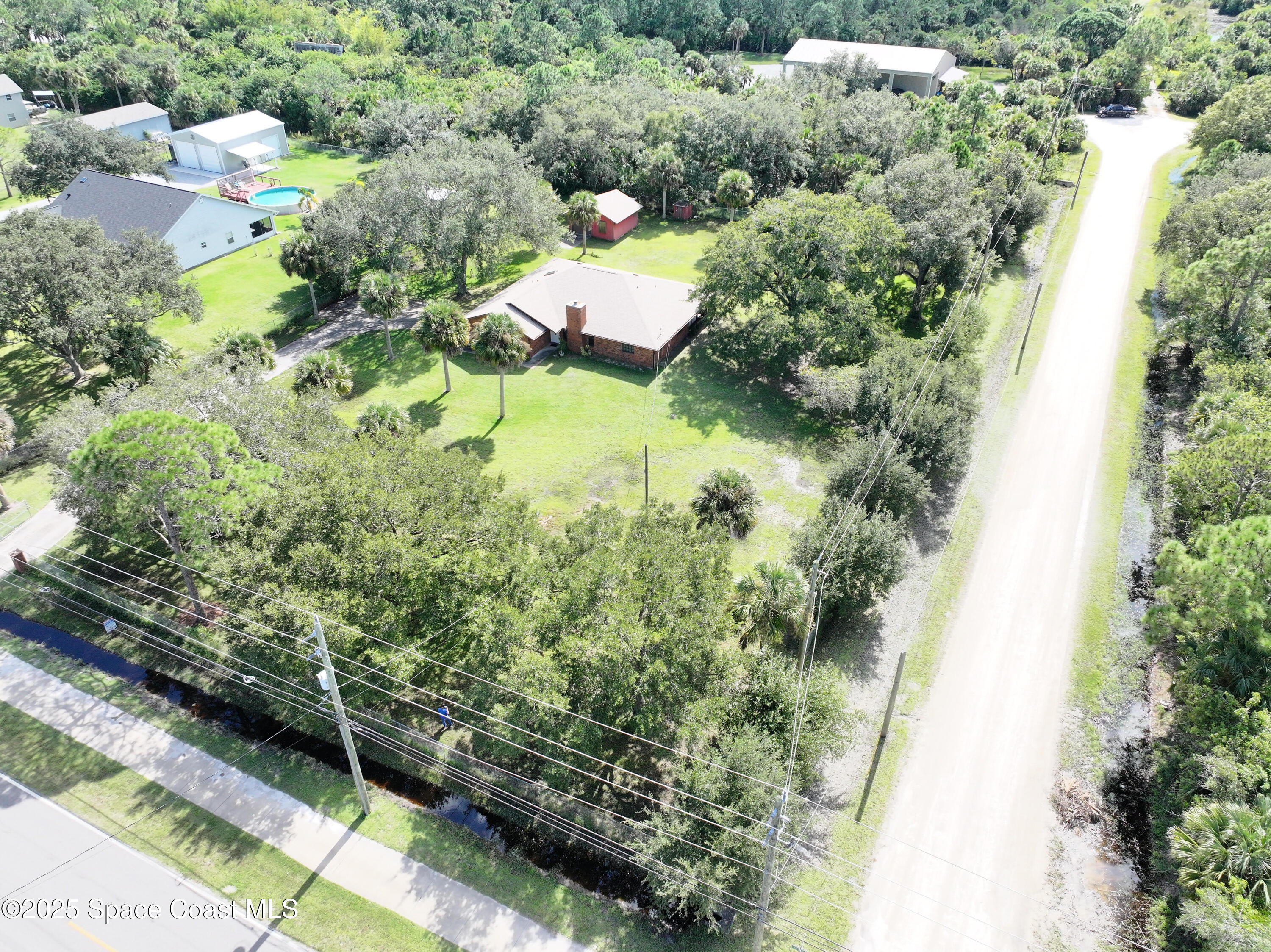 3301 Grant Road Grant-Valkaria, FL 32949 - Photo 39 of 56 an aerial view of a house with a yard