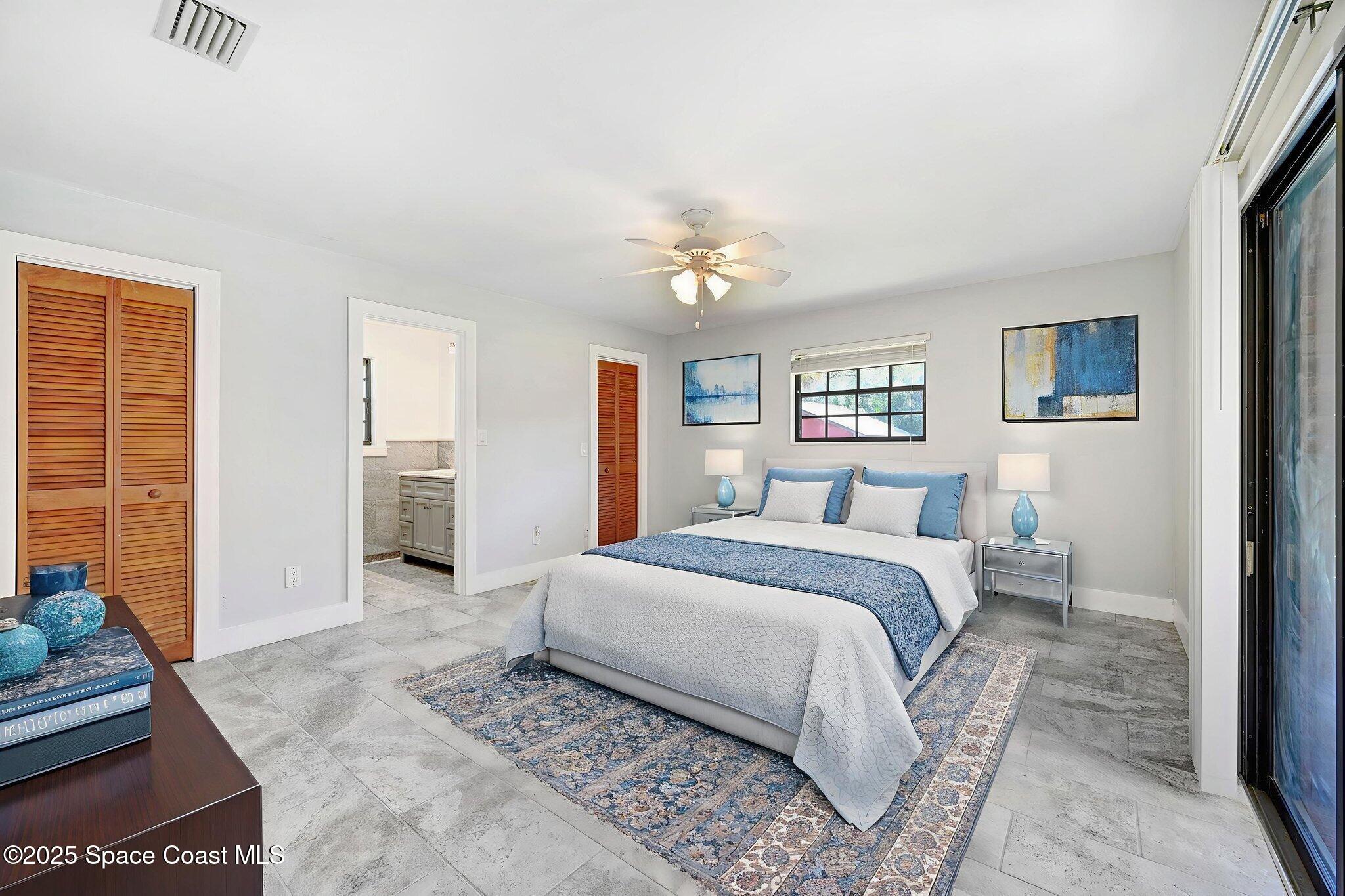 3301 Grant Road Grant-Valkaria, FL 32949 - Photo 3 of 56 a spacious bedroom with a large bed and a chandelier