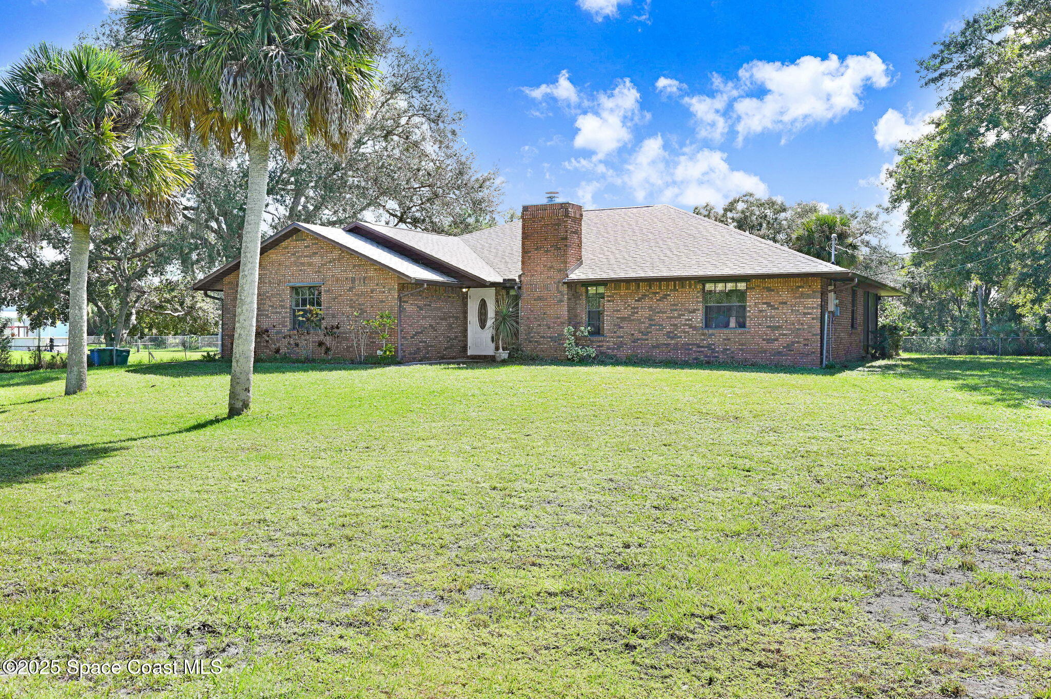 3301 Grant Road Grant-Valkaria, FL 32949 - Photo 45 of 56 a view of a house with a yard and potted plants
