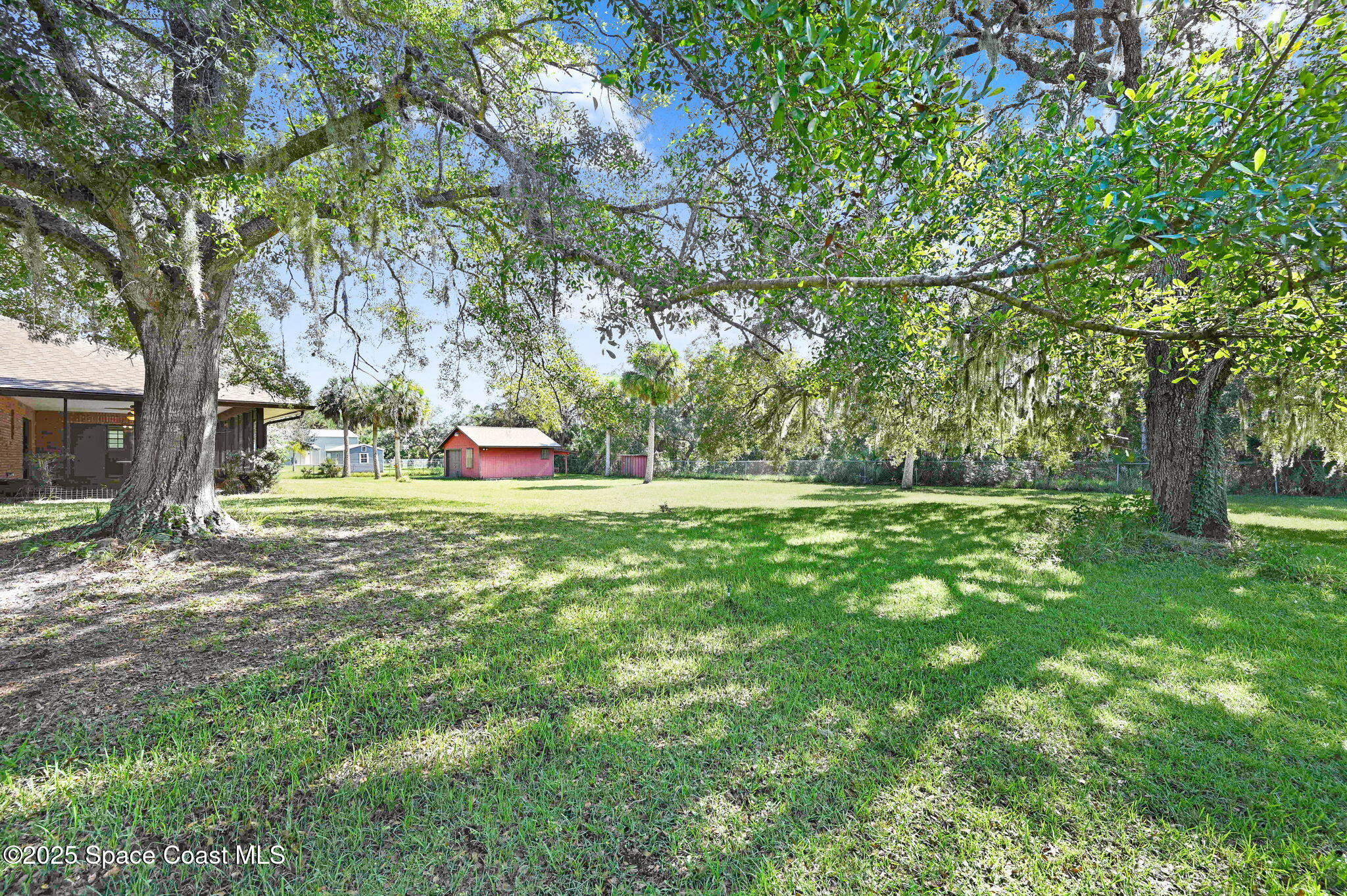 3301 Grant Road Grant-Valkaria, FL 32949 - Photo 49 of 56 a green field with lots of trees in the background