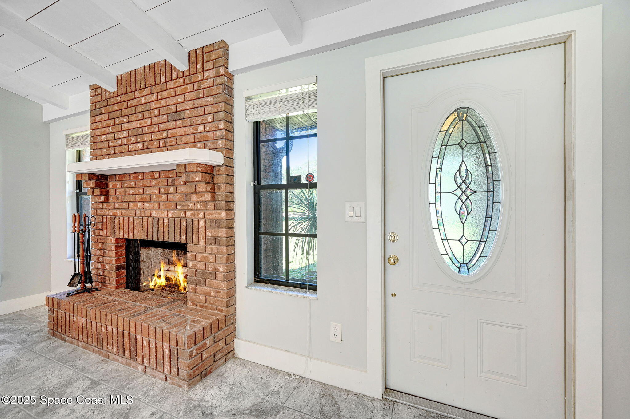 3301 Grant Road Grant-Valkaria, FL 32949 - Photo 6 of 56 a living room with furniture and a fireplace
