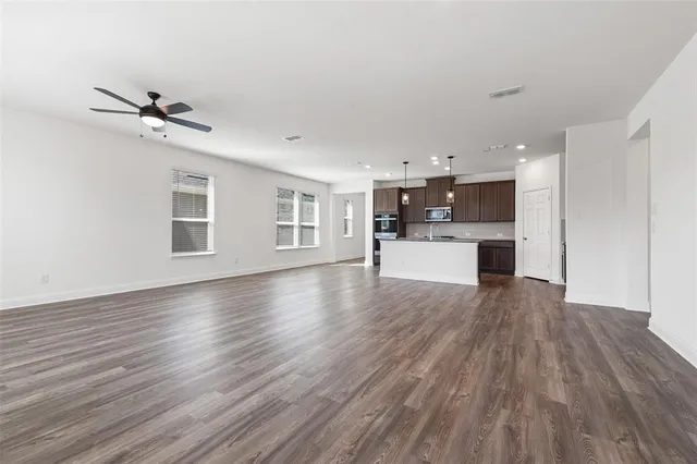 a view of a kitchen with a wooden floor and a kitchen