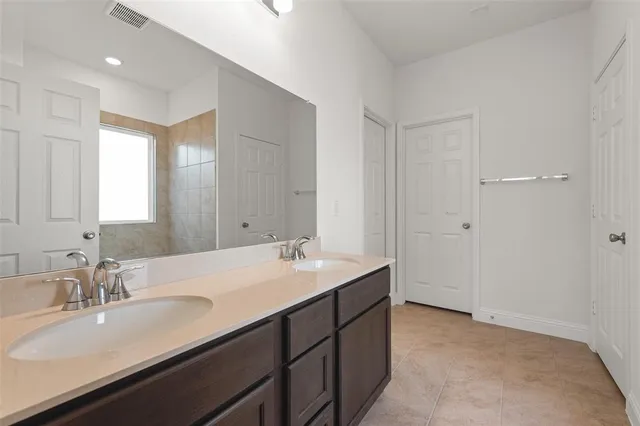 a bathroom with a sink double vanity and a mirror