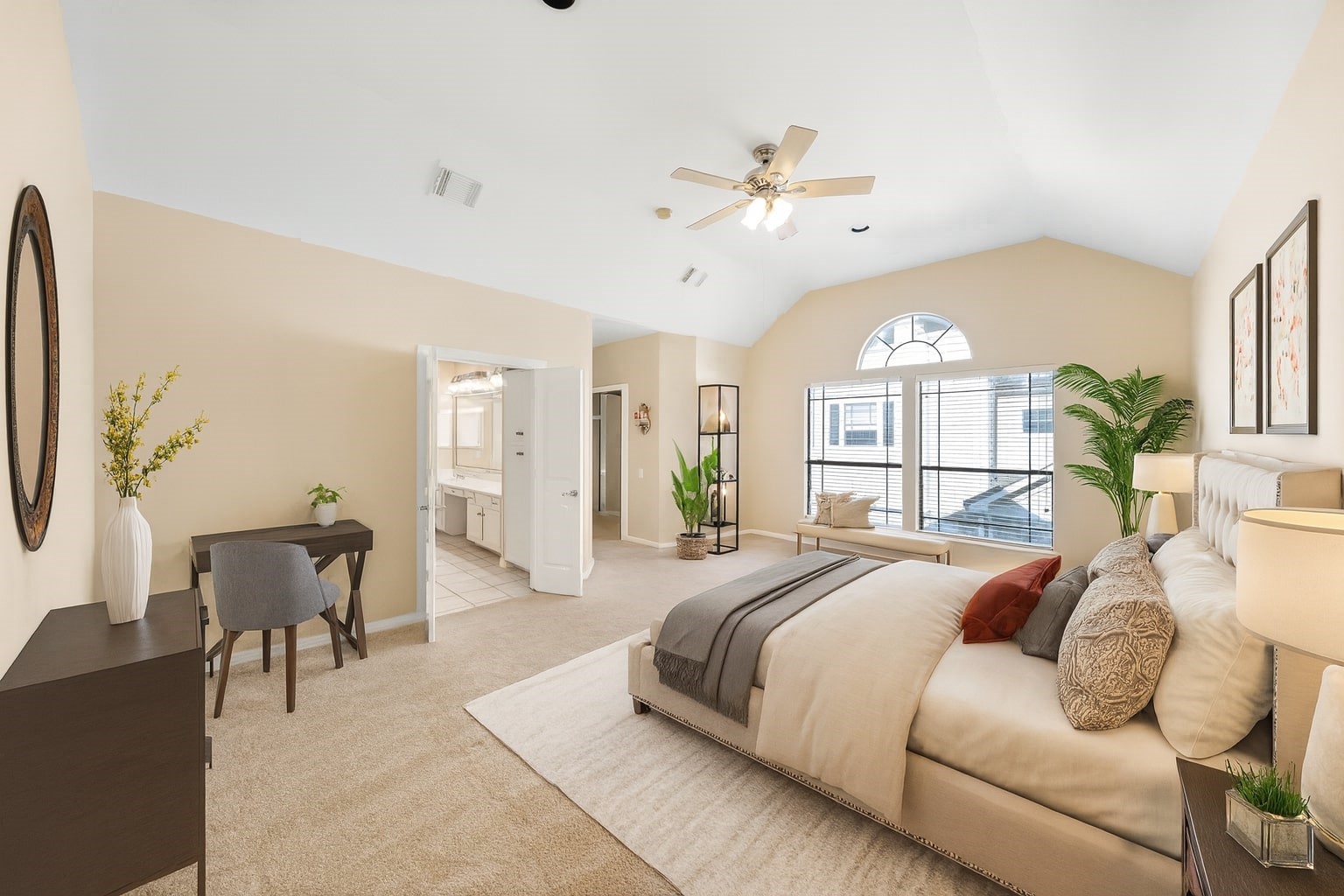 a spacious bedroom with a large bed and a chandelier