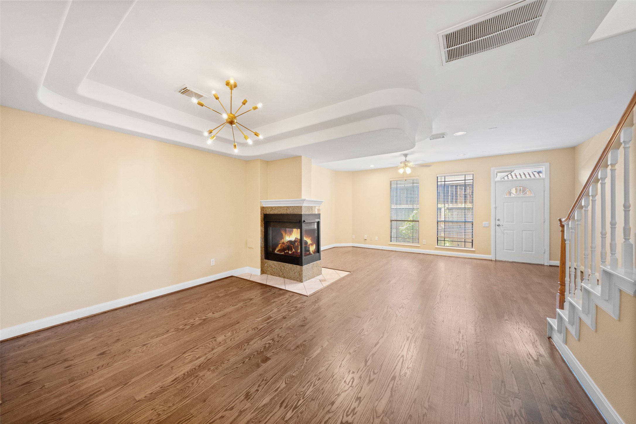 2406 Calumet Street Houston, TX 77004 - Photo 19 of 37 an empty room with wooden floor fireplace and windows