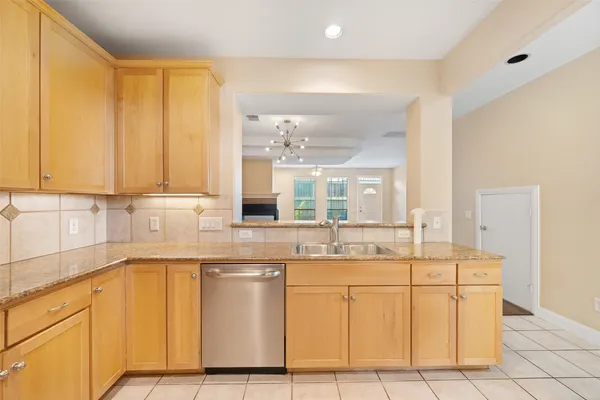 a kitchen with stainless steel appliances granite countertop a sink and cabinets