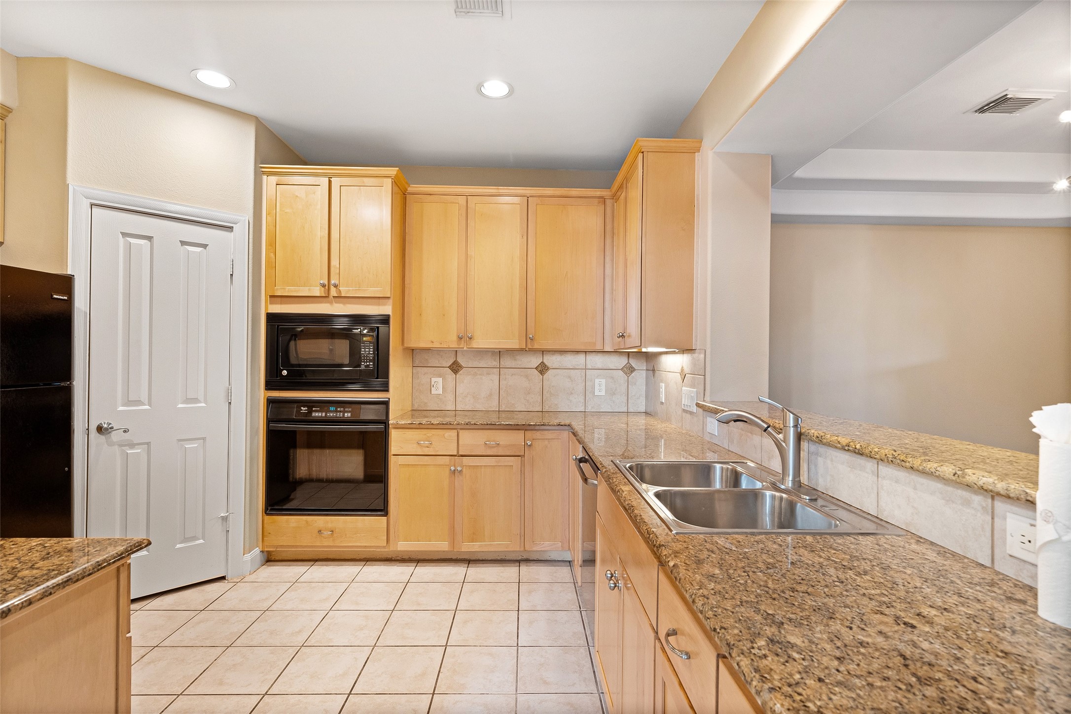 2406 Calumet Street Houston, TX 77004 - Photo 23 of 37 a kitchen with granite countertop a sink stainless steel appliances and cabinets