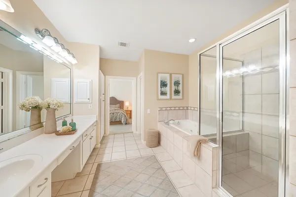 a spacious bathroom with a tub shower and sink