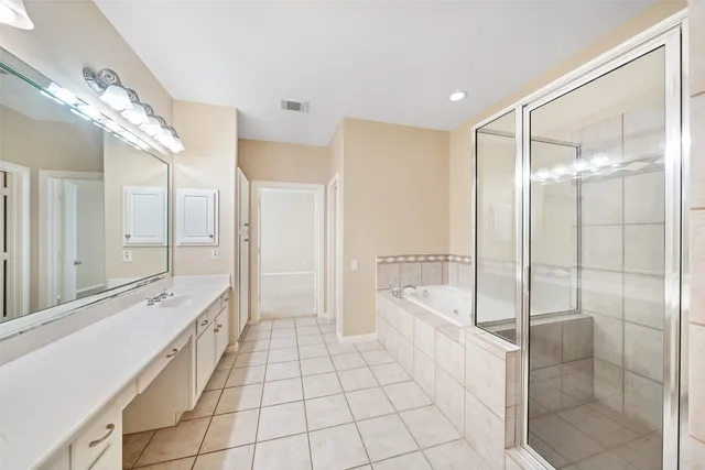 a spacious bathroom with a tub shower and sink