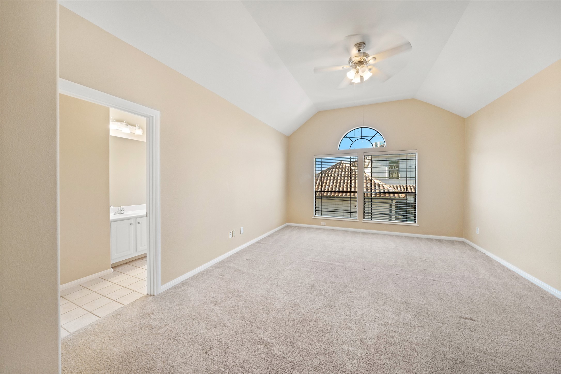 2406 Calumet Street Houston, TX 77004 - Photo 8 of 37 an empty room with windows and chandelier fan