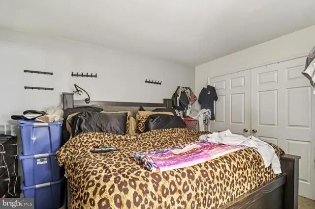 a bedroom with a bed and cabinets