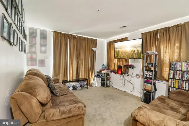 a view of living room with furniture and a large window