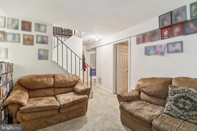 a living room with furniture and a book shelf
