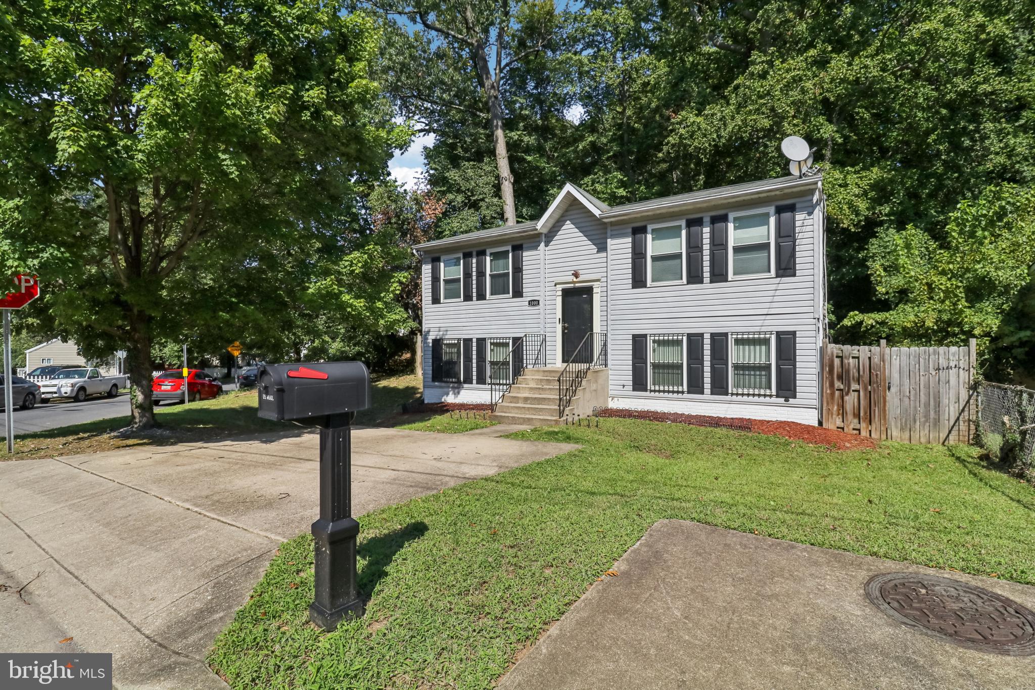 1000 Ute Way Capitol Heights, MD 20743 - Photo 4 of 51 a front view of a house with a garden and trees