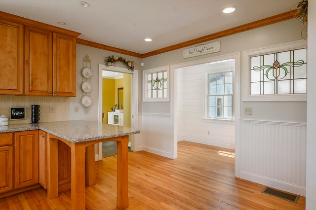 a kitchen with a sink cabinets and wooden floor