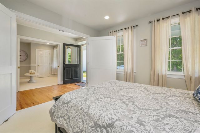 a bedroom with a large bed and a window