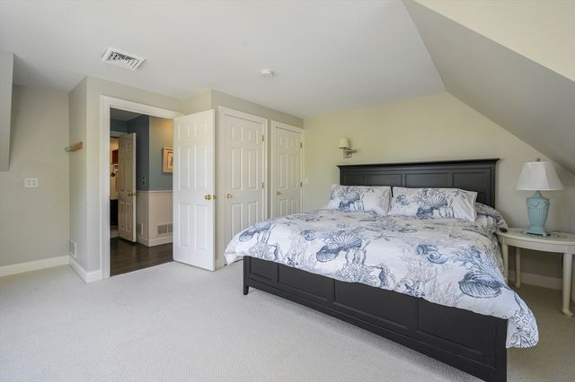 a bed sitting in a bedroom and closet