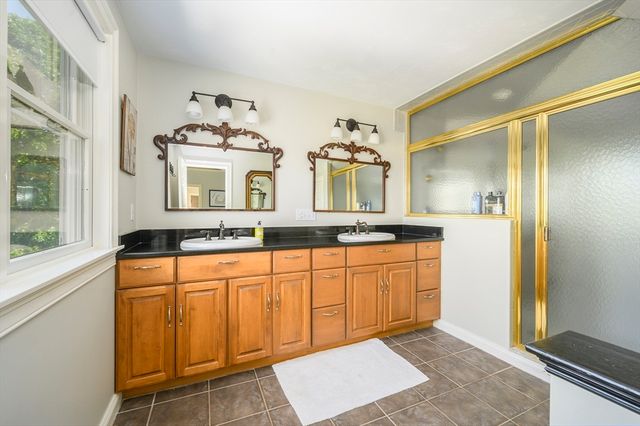 a large bathroom with a granite countertop sink and a mirror
