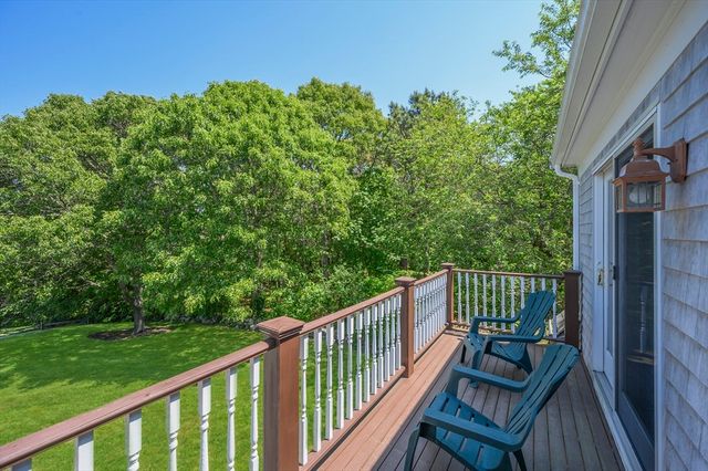 a view of a balcony with wooden floor and fence