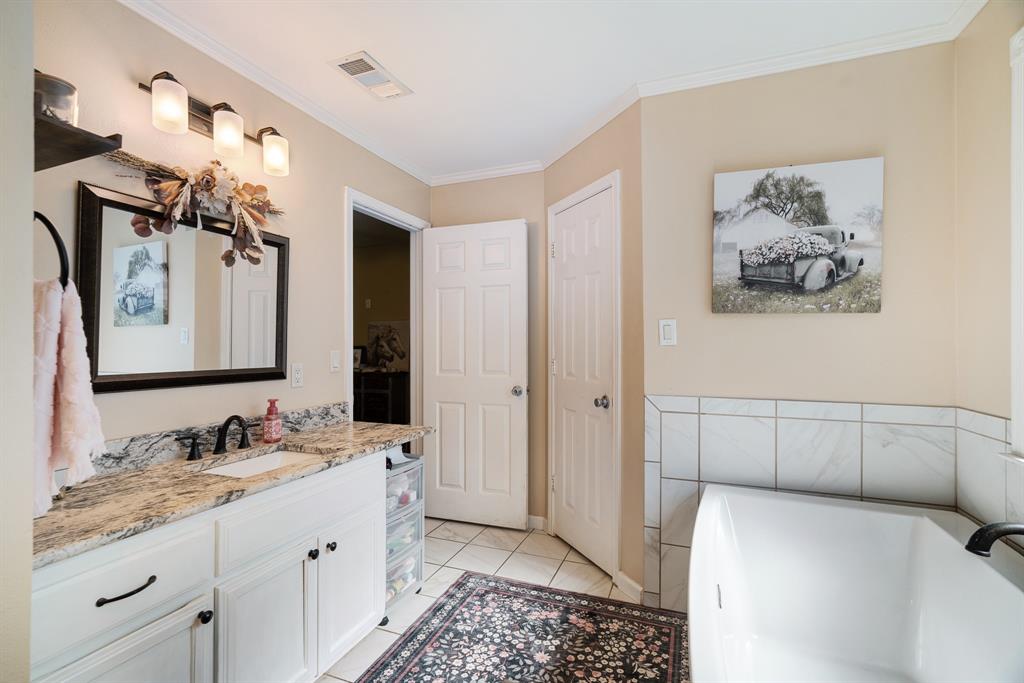 258 County Road Powderly, TX 75473 - Photo 14 of 24 a bathroom with a double vanity sink and a mirror