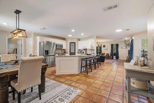 a large kitchen with a table and chairs