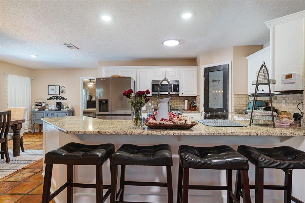 258 County Road Powderly, TX 75473 - Photo 8 of 24 a kitchen with sink and chairs