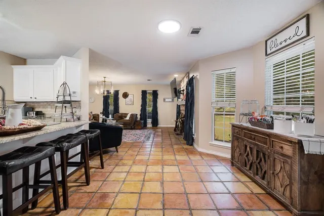 a large kitchen with lots of counter top space and stainless steel appliances