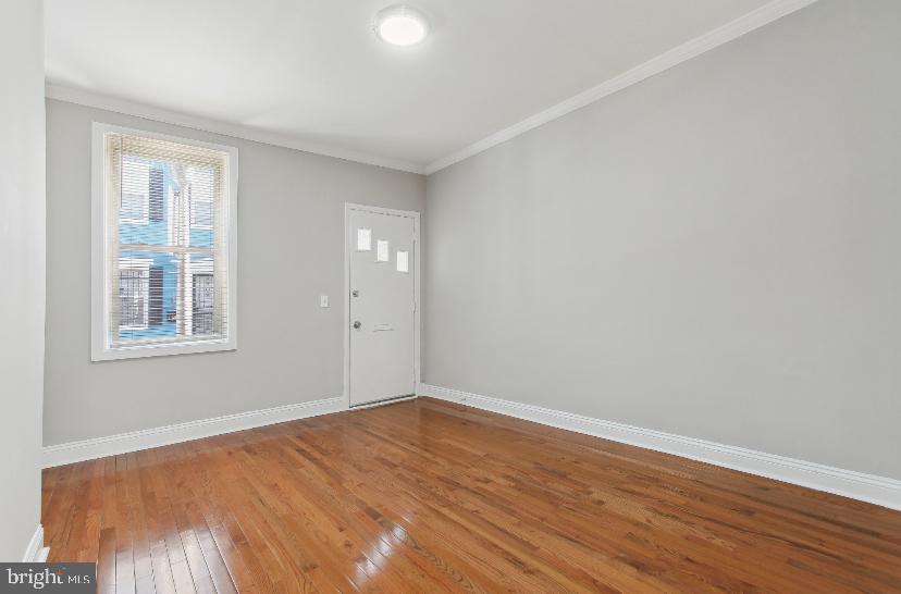 626 Archer Street Baltimore, MD 21230 - Photo 18 of 21 an empty room with wooden floor and windows