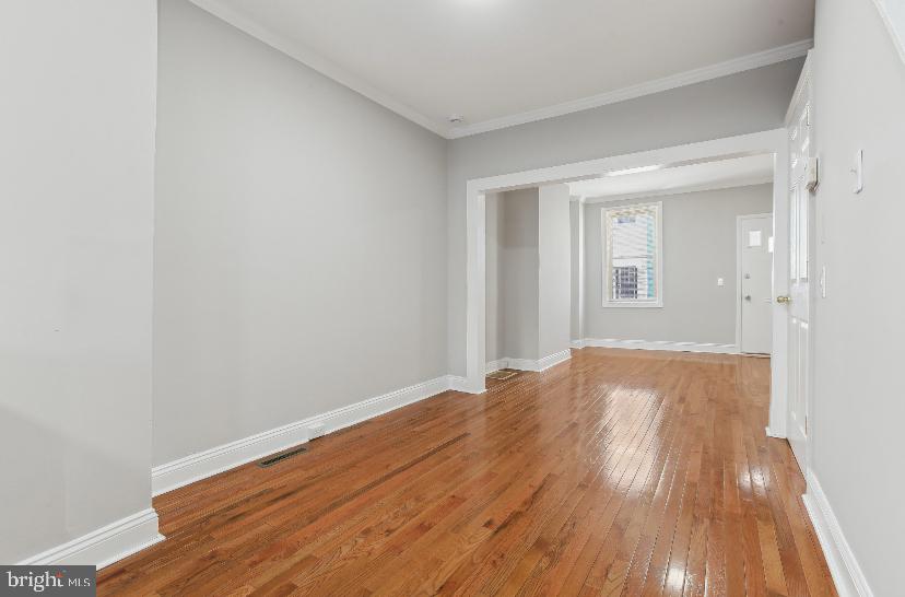 626 Archer Street Baltimore, MD 21230 - Photo 3 of 21 a view of empty room with wooden floor