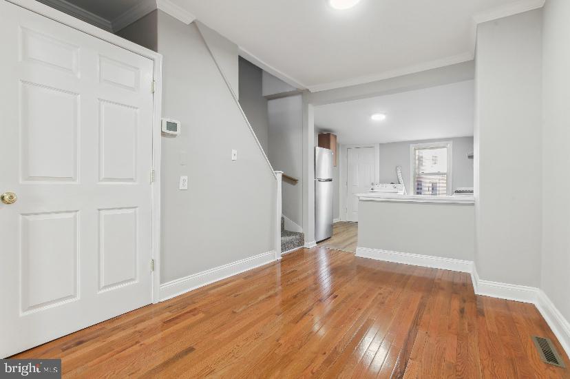 626 Archer Street Baltimore, MD 21230 - Photo 4 of 21 a view of empty room with wooden floor