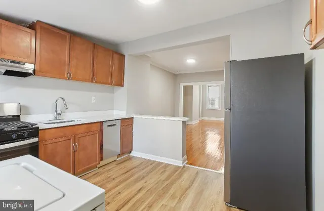 a kitchen with stainless steel appliances granite countertop a refrigerator and a sink