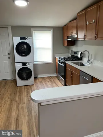 a kitchen with a stove a sink and a cabinets