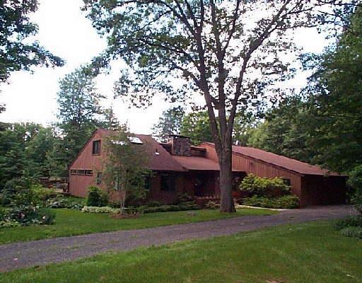 6 Woods Road Sherman, CT 06784 - Photo 1 of 1 a front view of house with yard and green space