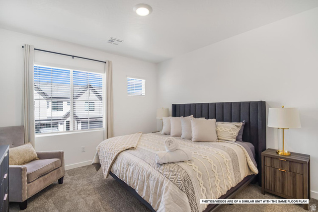 1702 Ripple Rock Drive, Unit 3171 Washington, UT 84780 - Photo 4 of 16 Carpeted bedroom featuring white walls, a large window with blinds and curtains, and a smaller upper window