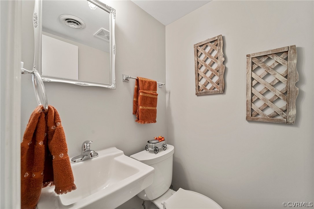 2304 Lashley Lane Henrico, VA 23238 - Photo 18 of 29 a white toilet sitting next to a bathroom sink