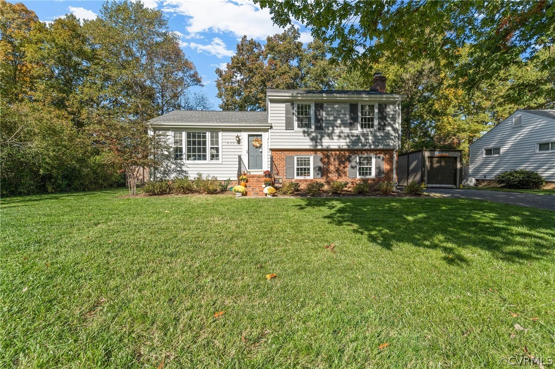 2304 Lashley Lane Henrico, VA 23238 - Photo 2 of 29 a front view of a house with a garden