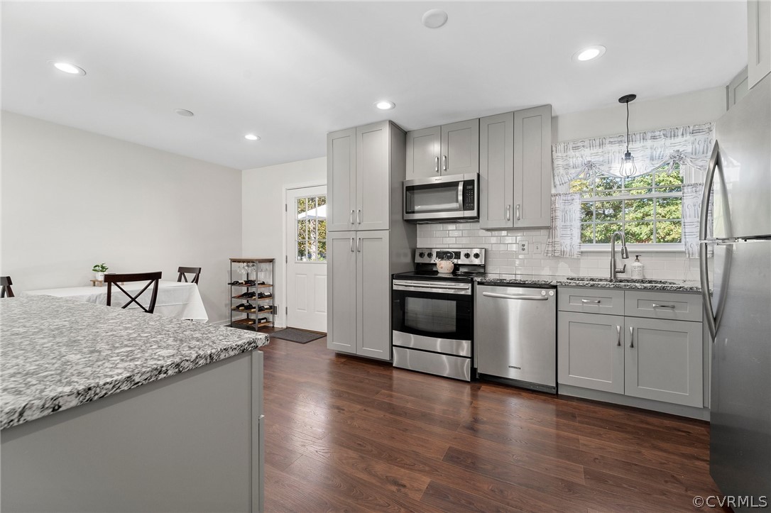2304 Lashley Lane Henrico, VA 23238 - Photo 7 of 29 a kitchen with stainless steel appliances kitchen island granite countertop a stove a sink and a refrigerator