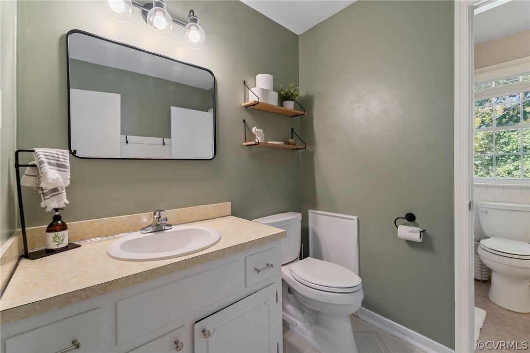 2304 Lashley Lane Henrico, VA 23238 - Photo 9 of 29 a bathroom with a toilet a sink a vanity and mirror