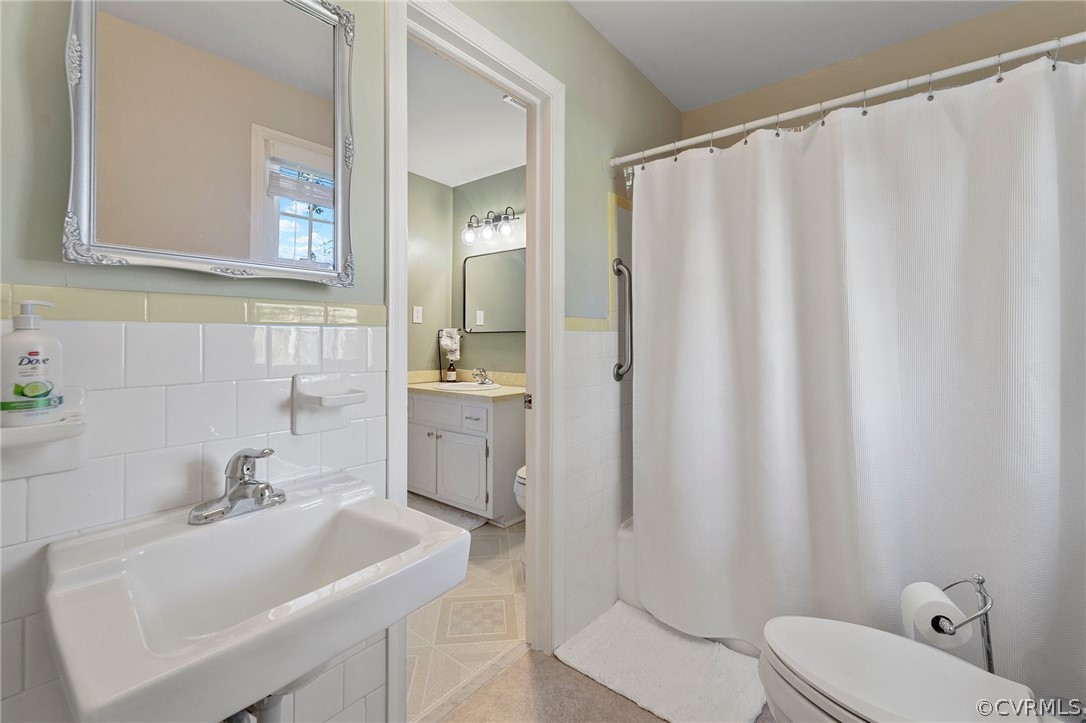 2304 Lashley Lane Henrico, VA 23238 - Photo 10 of 29 a bathroom with a sink a toilet and shower curtain