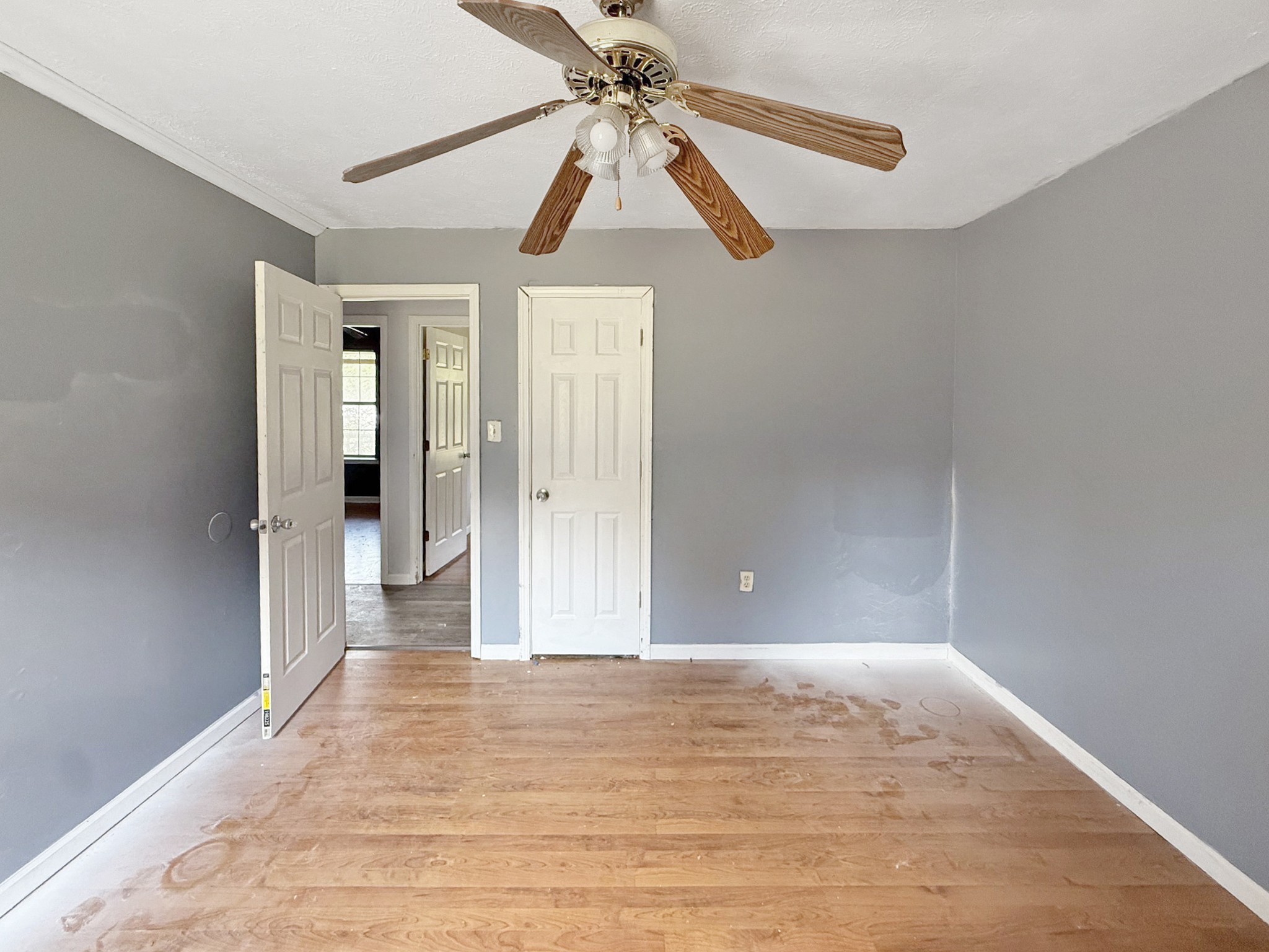 607 Cool Springs Road Morgantown, KY 42261 - Photo 16 of 18 a view of a hallway with a chandelier fan and wooden floor