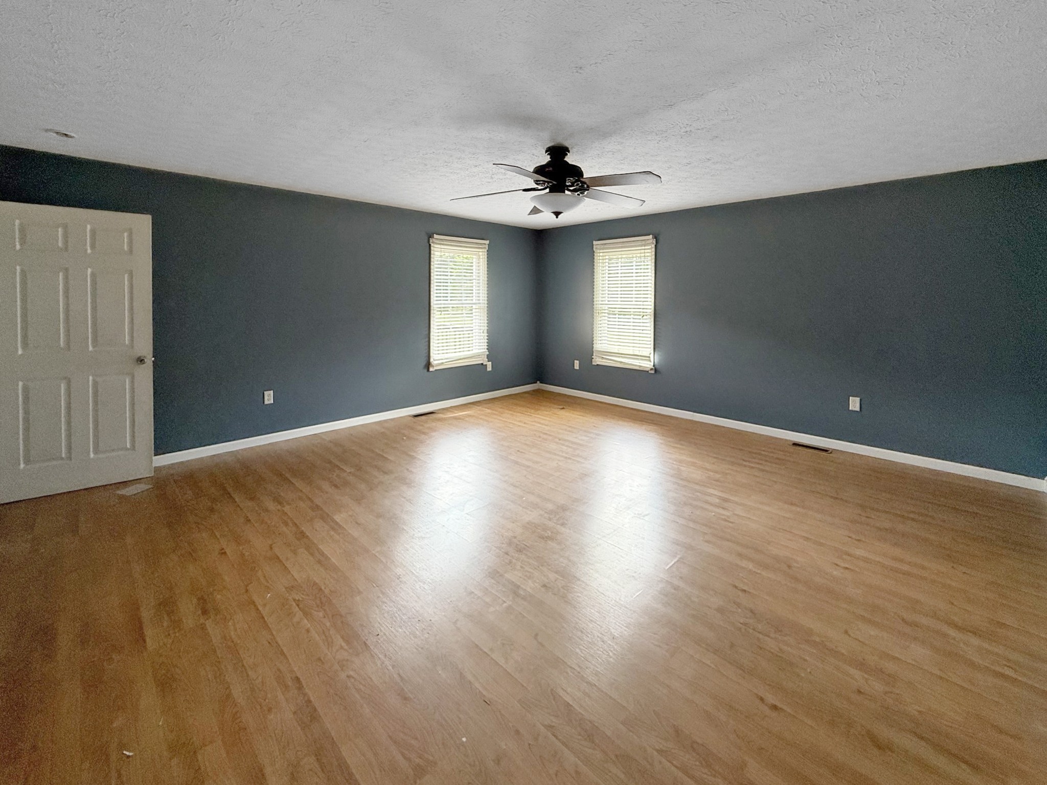 607 Cool Springs Road Morgantown, KY 42261 - Photo 8 of 18 a view of an empty room with window and wooden floor