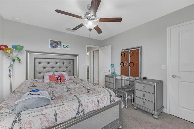 a bedroom with a bed and a dresser in it