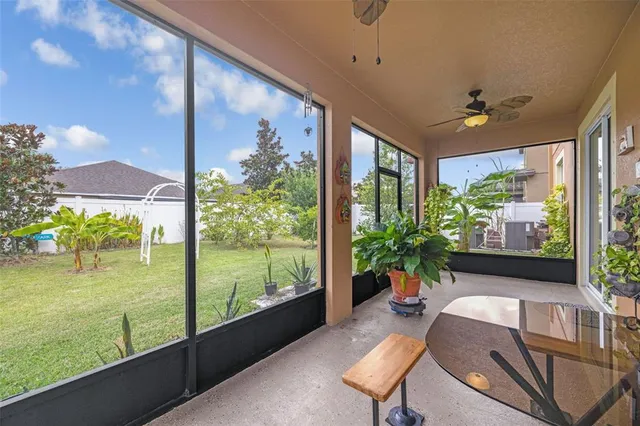 a living room filled with furniture and a potted plant